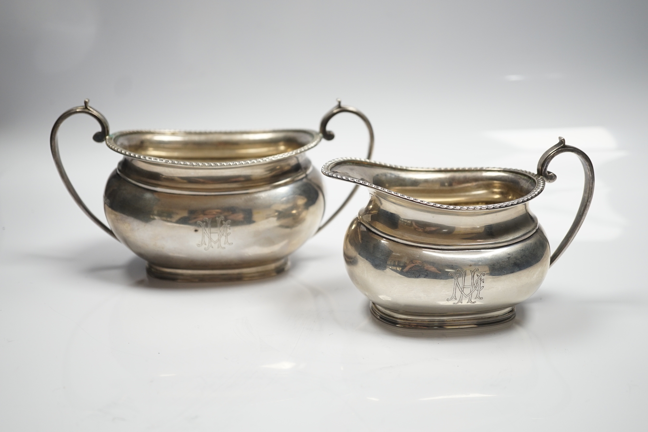 A George V silver oval cream jug and sugar bowl, Sebastian Garrard, London, 1927, 14.8oz.